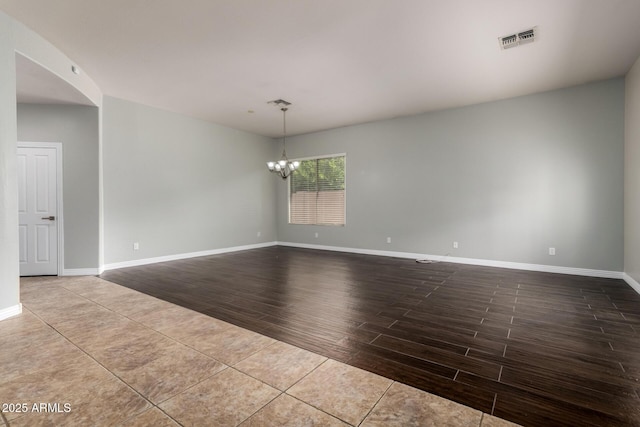 702 E Capricorn Way, Chandler, AZ 85249 - unfurnished room featuring wood finish floors, a chandelier, and baseboards