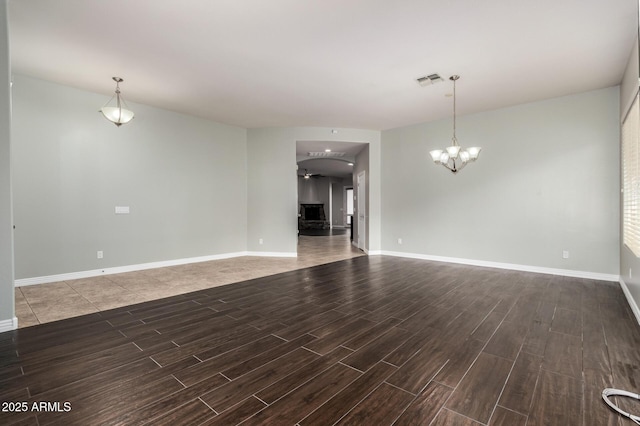 702 E Capricorn Way, Chandler, AZ 85249 - unfurnished living room featuring wood tiled floors, a chandelier, and baseboards