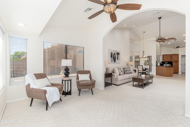 carpeted living room featuring high vaulted ceiling and ceiling fan