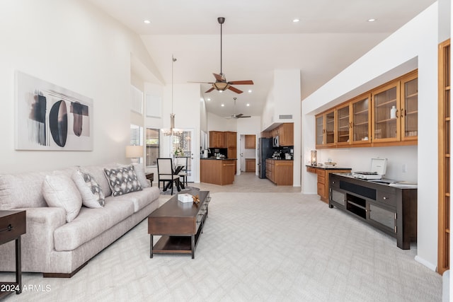 carpeted living room with high vaulted ceiling and ceiling fan