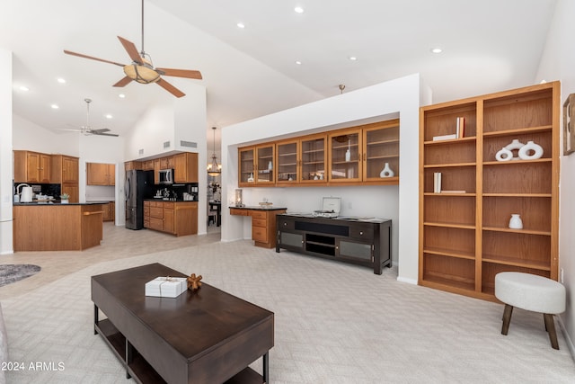 carpeted living room featuring high vaulted ceiling and ceiling fan