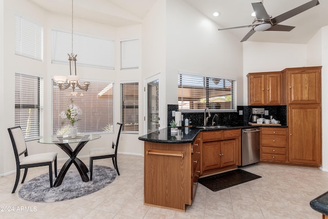 kitchen with ceiling fan with notable chandelier, backsplash, sink, hanging light fixtures, and stainless steel dishwasher