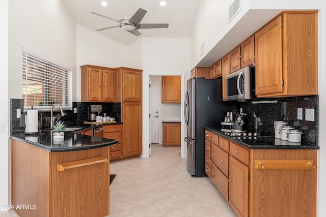 kitchen with ceiling fan, sink, high vaulted ceiling, and tasteful backsplash