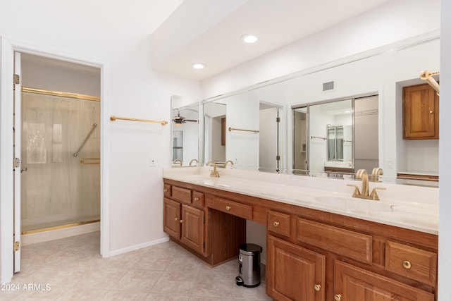 bathroom with vanity, a shower with shower door, ceiling fan, and tile patterned flooring