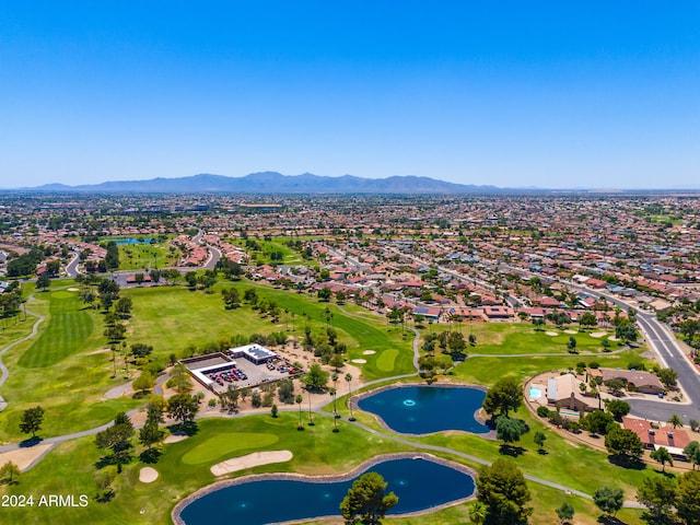 birds eye view of property with a water and mountain view