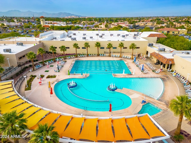 view of swimming pool with a mountain view and a patio