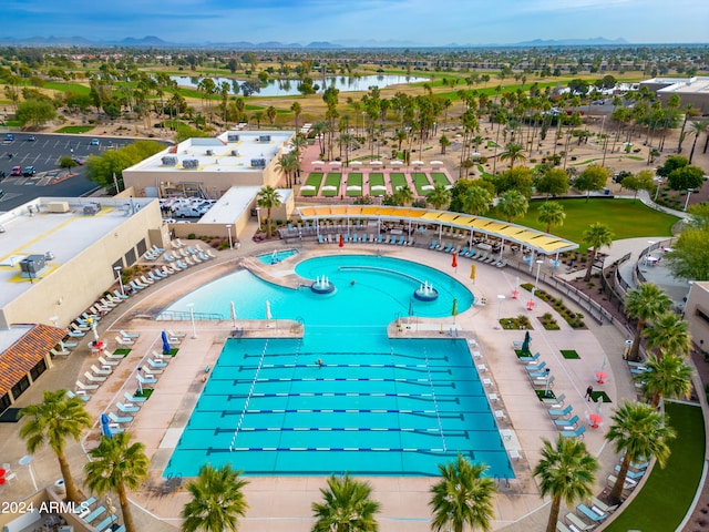 view of swimming pool with a water view and a patio area