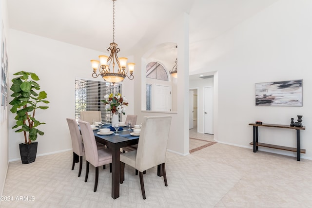 dining space featuring light tile patterned floors and an inviting chandelier