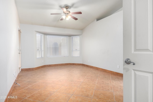 unfurnished room with light tile patterned floors, a ceiling fan, and baseboards