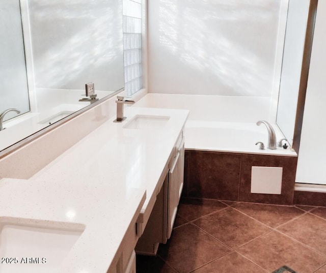 bathroom featuring a garden tub, tile patterned floors, and vanity