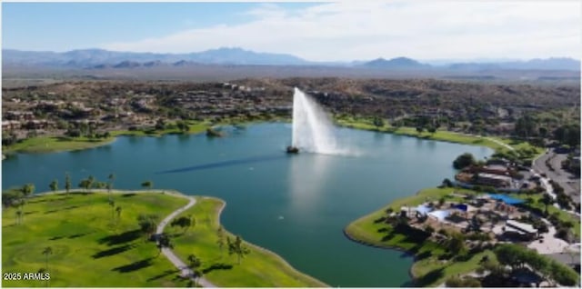 birds eye view of property with a water and mountain view