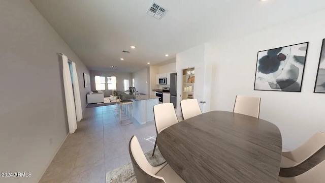 dining area featuring light tile patterned floors