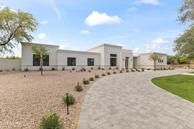 9611 E Clinton St, Scottsdale, AZ 85260 - contemporary house featuring curved driveway and stucco siding