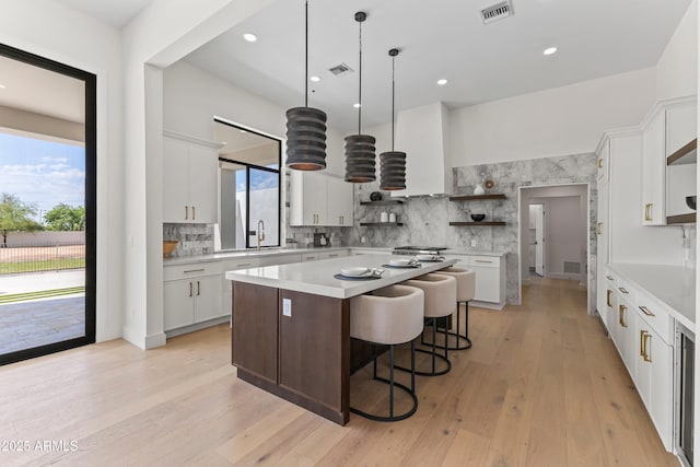 9611 E Clinton St, Scottsdale, AZ 85260 - kitchen featuring open shelves, light countertops, a kitchen island, tasteful backsplash, and recessed lighting