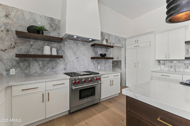 9611 E Clinton St, Scottsdale, AZ 85260 - kitchen with luxury range, open shelves, custom range hood, and tasteful backsplash
