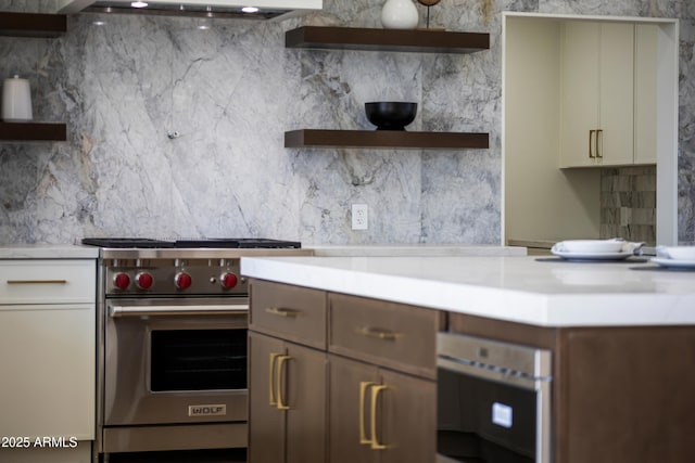 9611 E Clinton St, Scottsdale, AZ 85260 - kitchen featuring open shelves, designer range, decorative backsplash, light countertops, and range hood