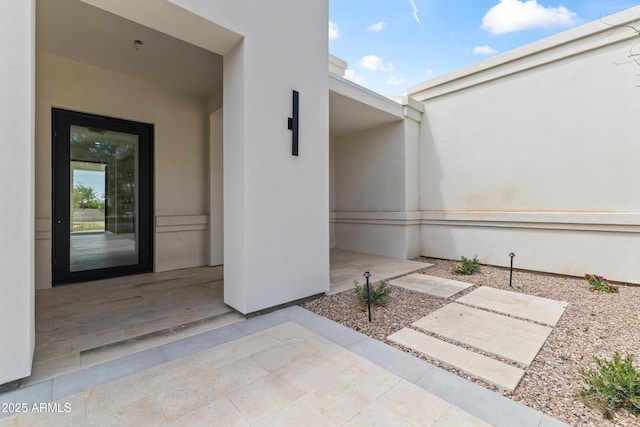 9611 E Clinton St, Scottsdale, AZ 85260 - doorway to property featuring stucco siding and a patio