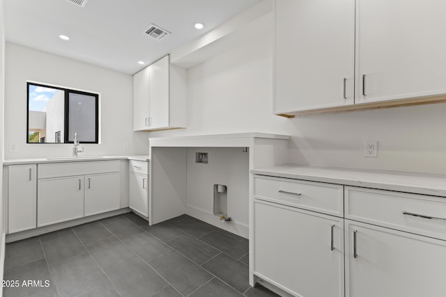 9611 E Clinton St, Scottsdale, AZ 85260 - washroom featuring cabinet space, hookup for a gas dryer, dark tile patterned flooring, hookup for a washing machine, and recessed lighting
