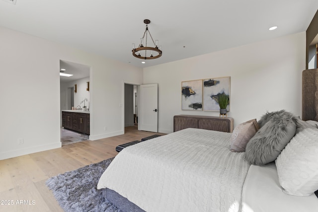 9611 E Clinton St, Scottsdale, AZ 85260 - bedroom featuring light wood-style flooring, baseboards, recessed lighting, and ensuite bath