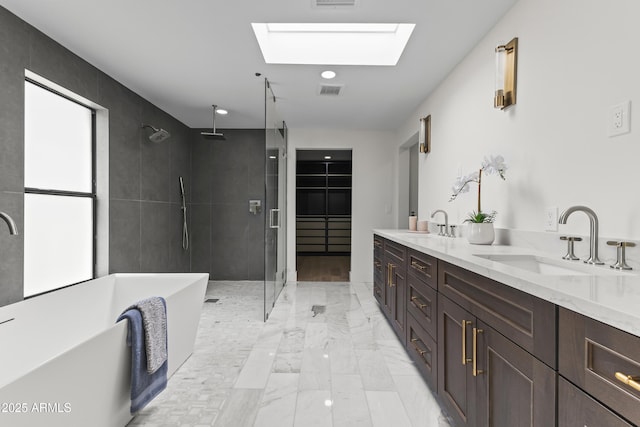9611 E Clinton St, Scottsdale, AZ 85260 - bathroom with a stall shower, a skylight, a soaking tub, marble finish floors, and double vanity