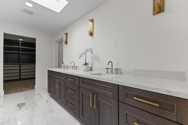 9611 E Clinton St, Scottsdale, AZ 85260 - bar area with a sink, a skylight, and light marble finish flooring