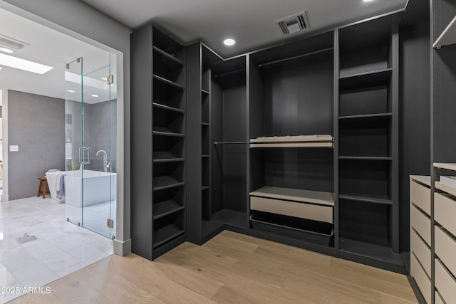 9611 E Clinton St, Scottsdale, AZ 85260 - walk in closet with wood finished floors
