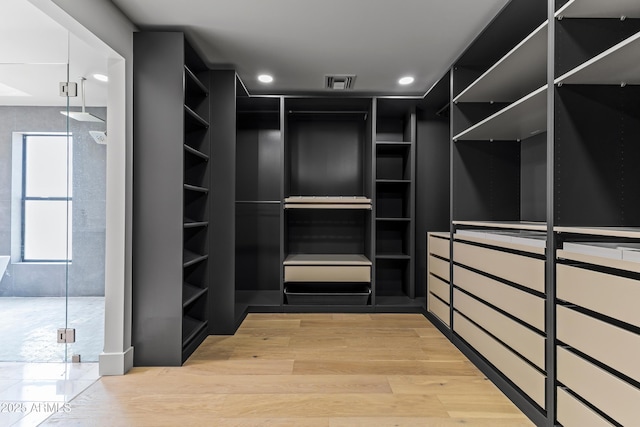 9611 E Clinton St, Scottsdale, AZ 85260 - spacious closet featuring light wood-style floors