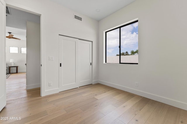 9611 E Clinton St, Scottsdale, AZ 85260 - unfurnished bedroom featuring baseboards, light wood-type flooring, and a closet