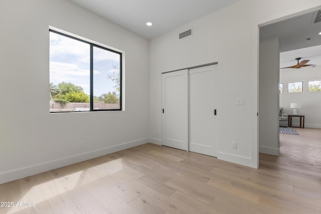 9611 E Clinton St, Scottsdale, AZ 85260 - unfurnished bedroom with light wood-style floors, baseboards, recessed lighting, and a closet