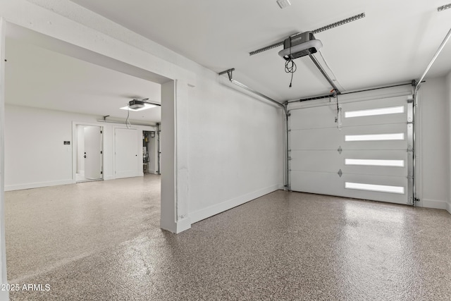 9611 E Clinton St, Scottsdale, AZ 85260 - garage with a garage door opener, baseboards, and ceiling fan
