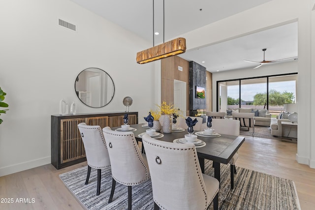 9611 E Clinton St, Scottsdale, AZ 85260 - dining room with wood finished floors, baseboards, a ceiling fan, a high ceiling, and recessed lighting