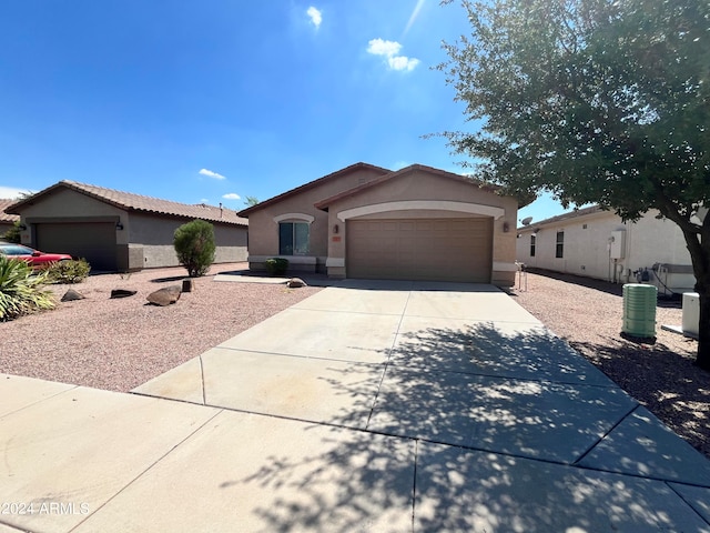 ranch-style house featuring a garage and central AC