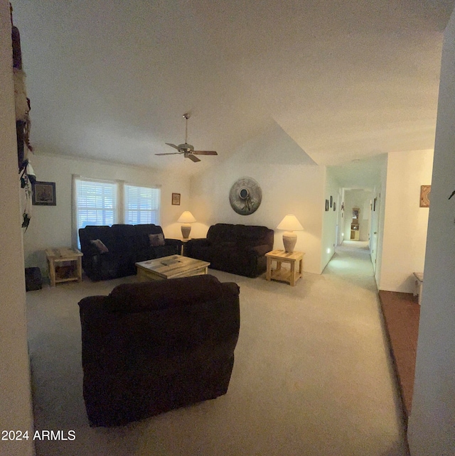 carpeted living room featuring vaulted ceiling and ceiling fan