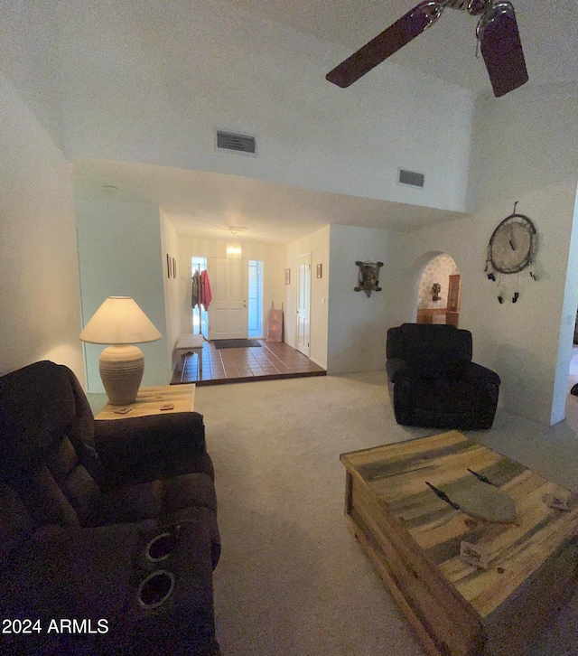 carpeted living room with ceiling fan and a textured ceiling