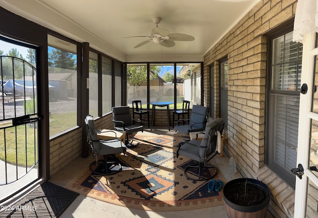 sunroom featuring a healthy amount of sunlight and ceiling fan