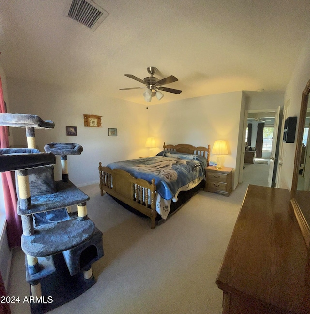 bedroom featuring light colored carpet and ceiling fan