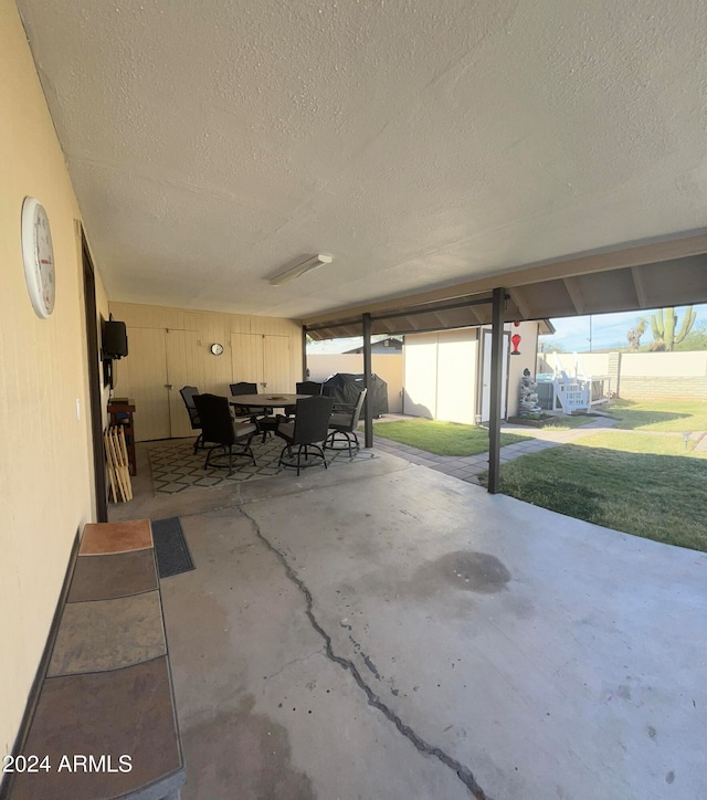 view of patio featuring a storage unit