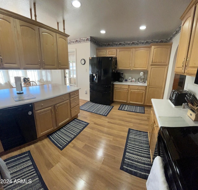 kitchen featuring black appliances, a textured ceiling, and light wood-type flooring