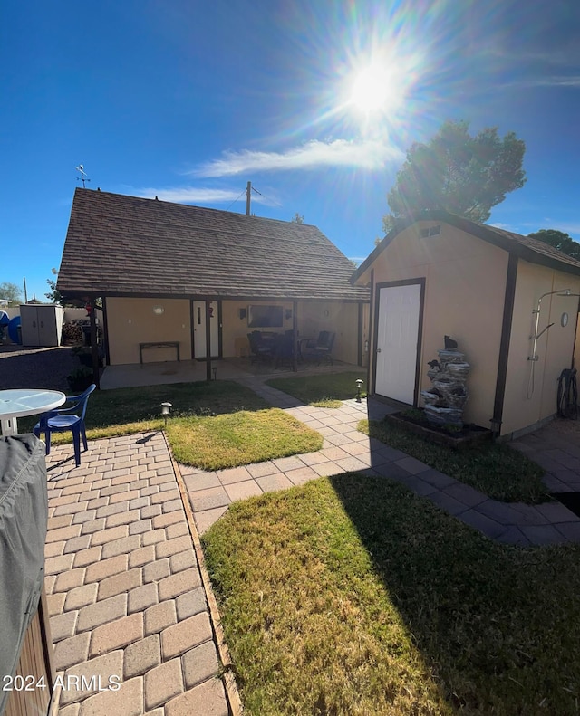 view of yard with a storage unit and a patio area