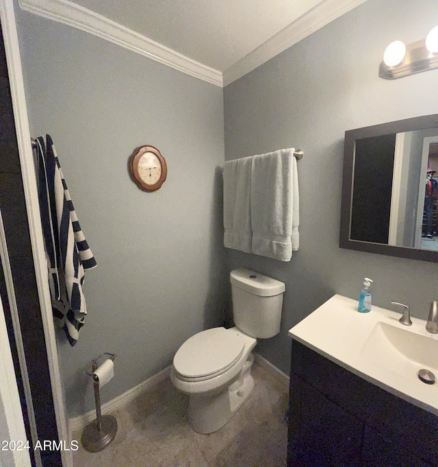 bathroom featuring vanity, toilet, and ornamental molding