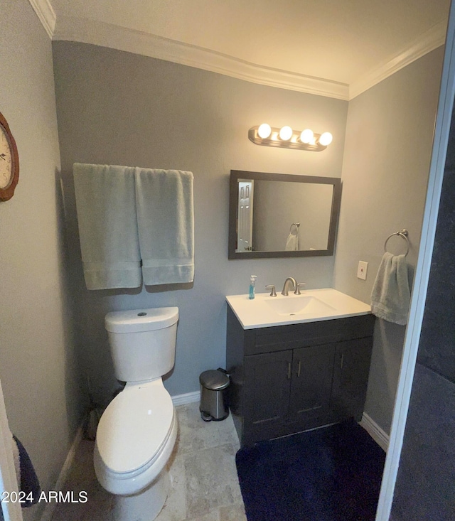 bathroom with toilet, crown molding, and vanity