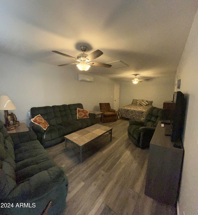 living room featuring an AC wall unit, hardwood / wood-style flooring, and ceiling fan