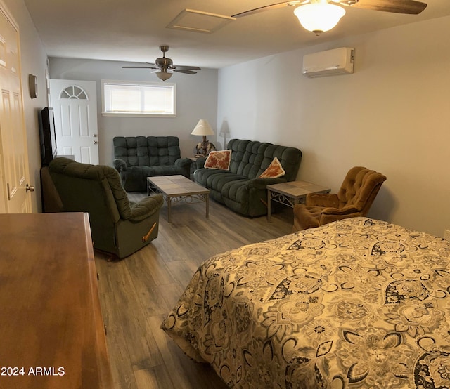 bedroom with hardwood / wood-style floors, a wall mounted air conditioner, and ceiling fan