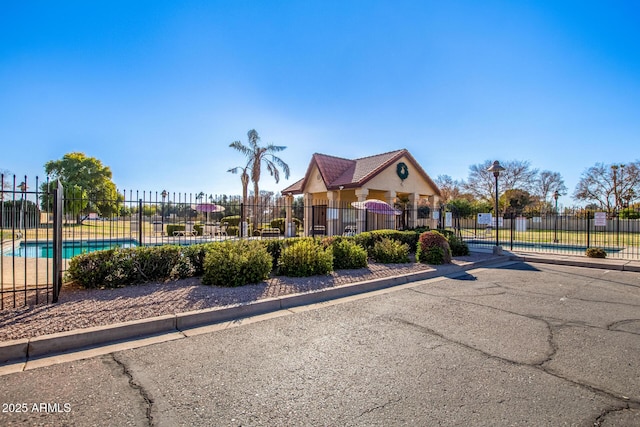 exterior space featuring fence and a community pool