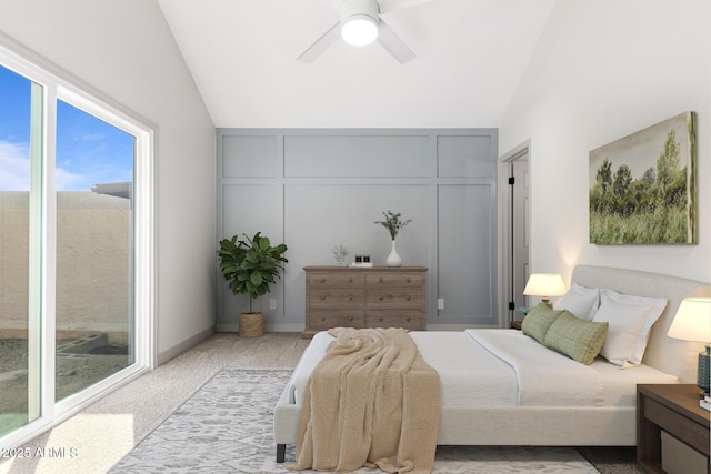 bedroom with a ceiling fan, lofted ceiling, light carpet, and a decorative wall