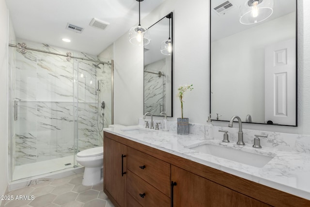 bathroom featuring a marble finish shower, a sink, and visible vents