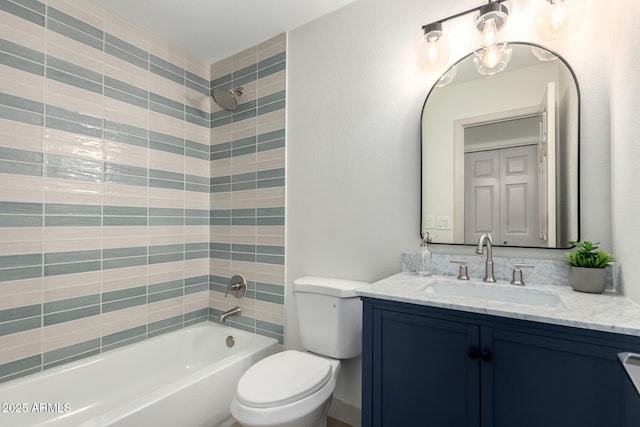 bathroom with tub / shower combination, vanity, and toilet