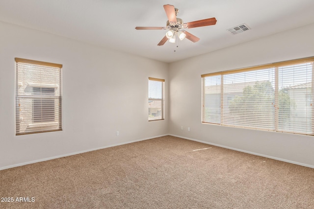 empty room featuring ceiling fan and carpet flooring