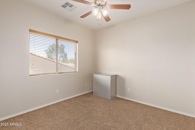 carpeted spare room with ceiling fan