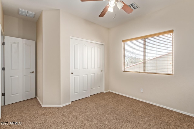 unfurnished bedroom with ceiling fan, a closet, and carpet floors